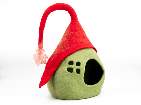 Green gnome-shaped pet bed with a red hat on a white background