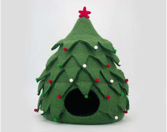 Green felt Christmas tree-shaped pet bed with red and white decorations on a light gray background