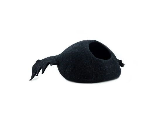 Black cat bed with a bow on a white background