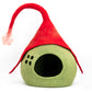 Green pet bed with a red gnome hat on a white background