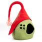 Green gnome-shaped pet bed with a red hat on a white background