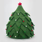 Green felt Christmas tree ornament with red and white decorations on a light gray background