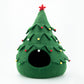 Green felt Christmas tree-shaped pet bed with decorative lights on a white background