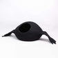 Black cat bed shaped like a duck on a white background