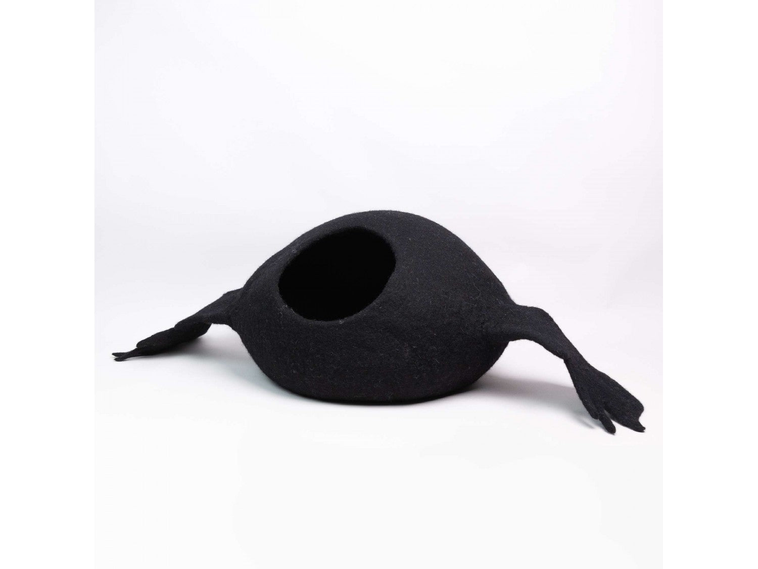 Black cat bed shaped like a duck on a white background