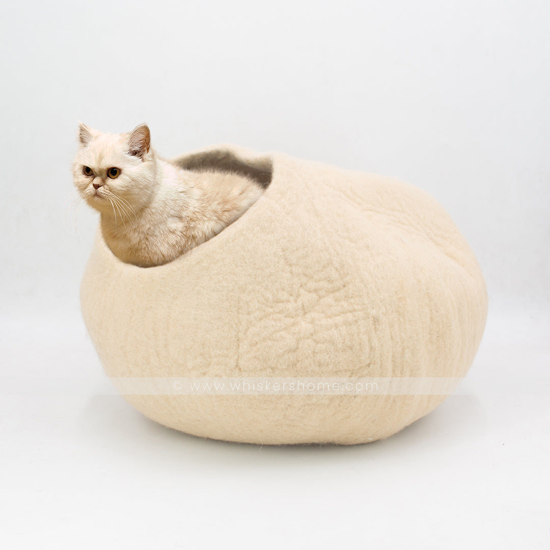 Cat relaxing inside light brown 100% wool felt cat cave bed