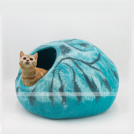 Cat relaxing inside ocean marble wool felt cat cave