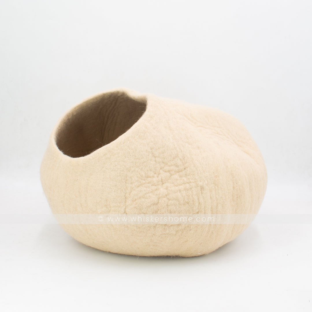 Side view of handcrafted light brown wool felt cat cave bed